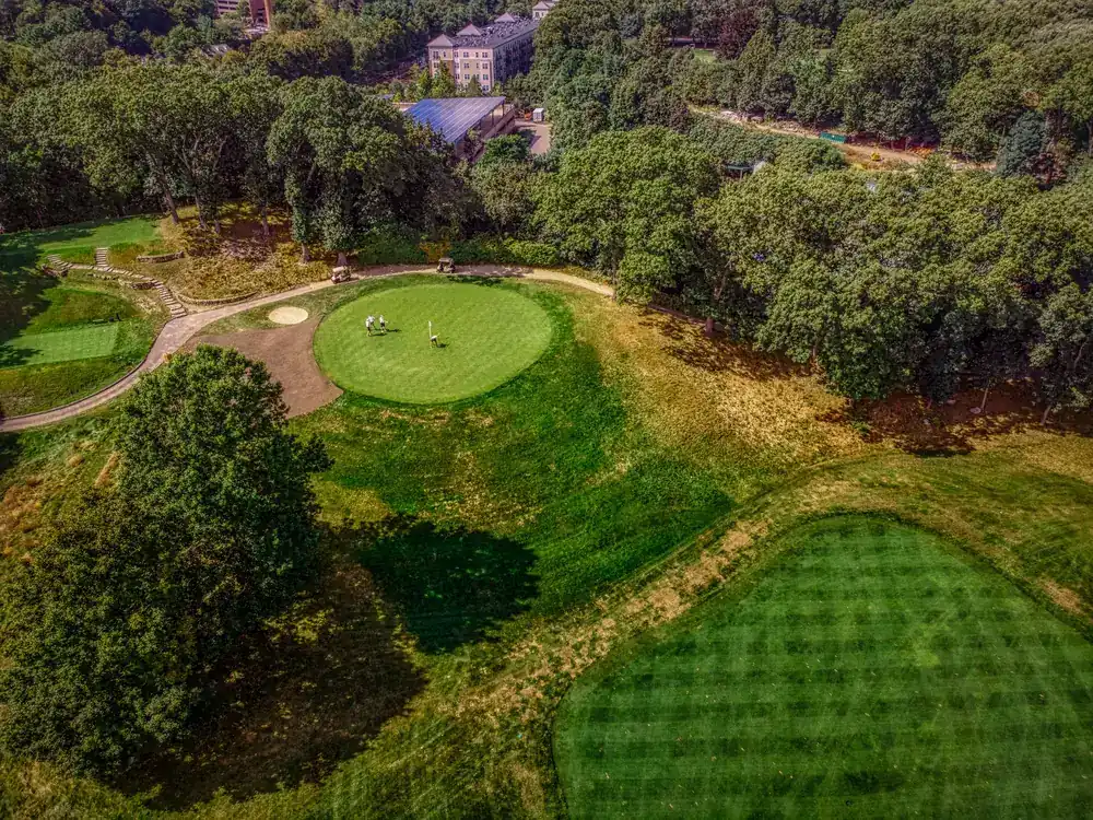 Aerial view of a golf course surrounded by trees